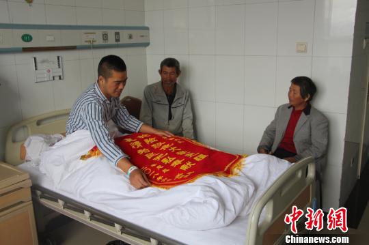 被救的李忠起、張總鳳夫婦看望受傷后的李運(yùn)飛。 汪渝 攝